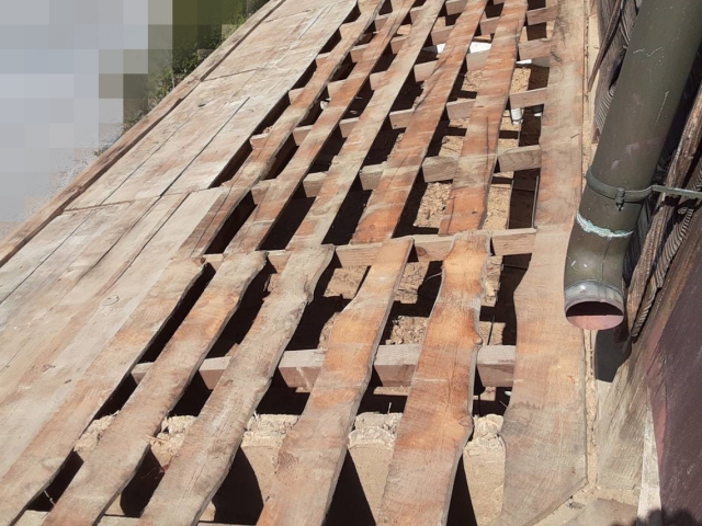 杉皮撤去完了し、傷んだ野地板（ザラ板）が露出した状態